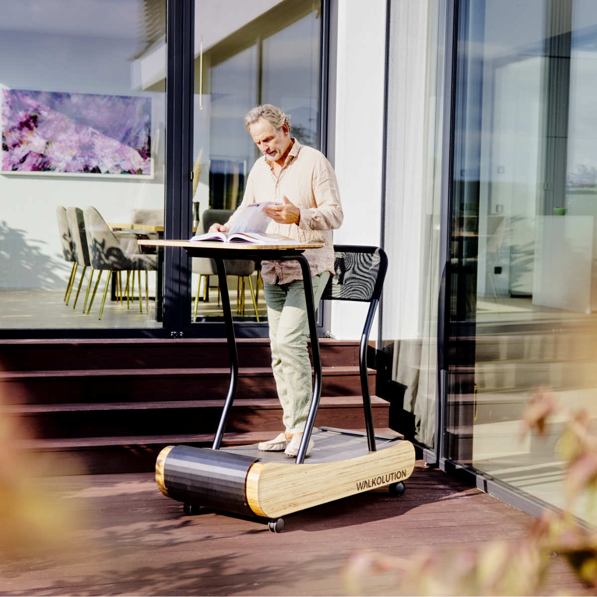 Man using treadmill desk on balcony garden outside Walkolution Germany